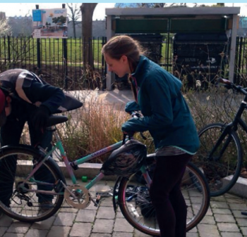 Two people fixing a bike