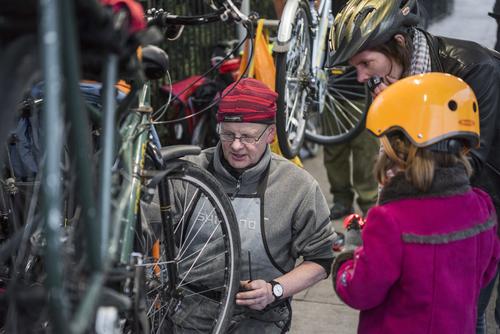 Bike mechanic fixes bike for Child